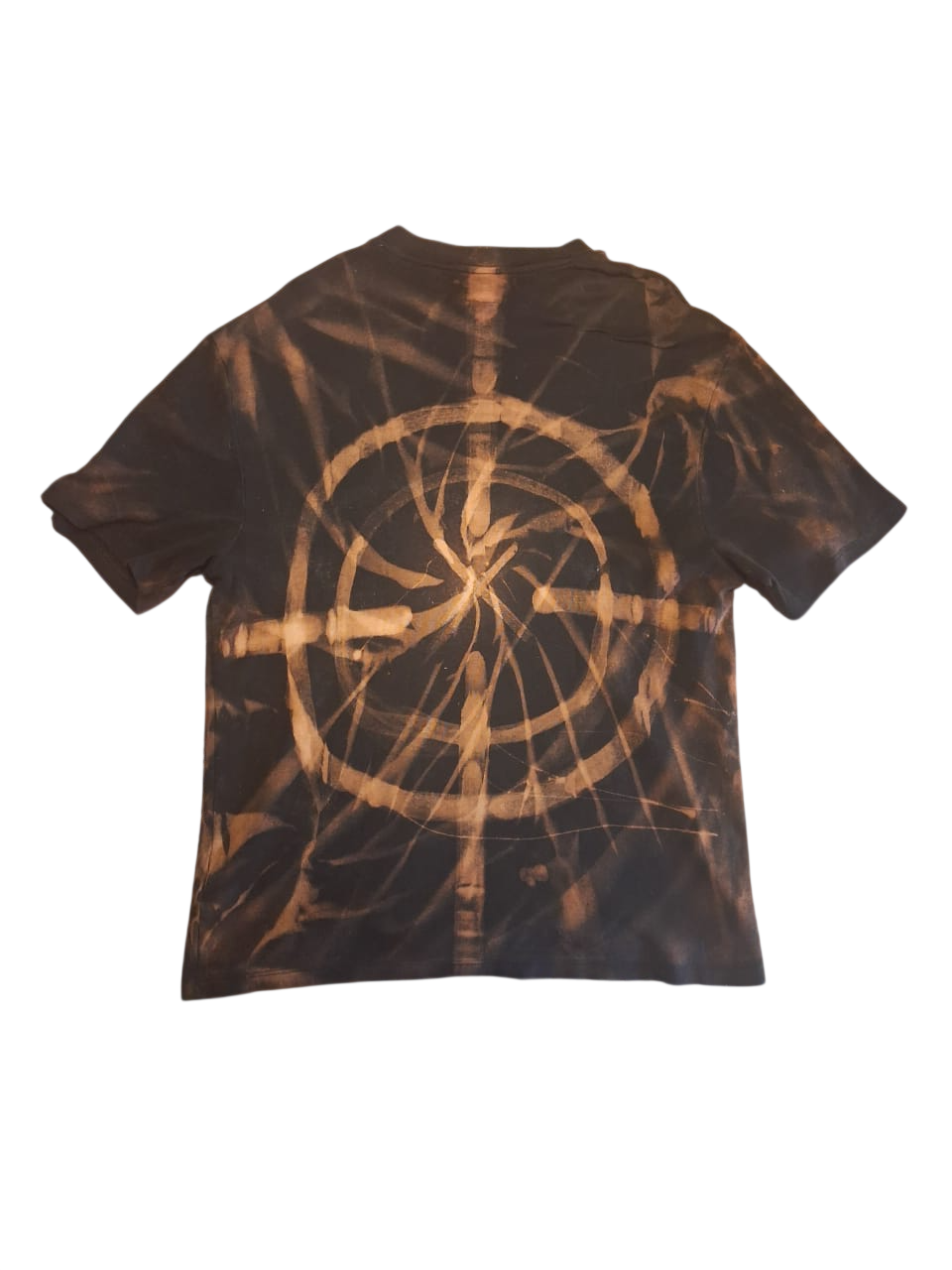 Back of the same dark shirt with a circular copper bleach design, shown upright