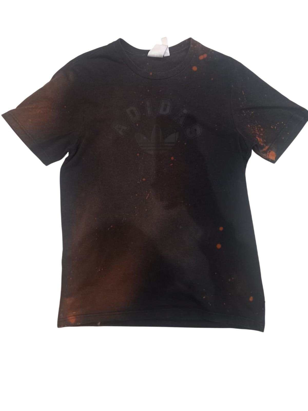 Front of the same black shirt with scattered rust-coloured bleach marks