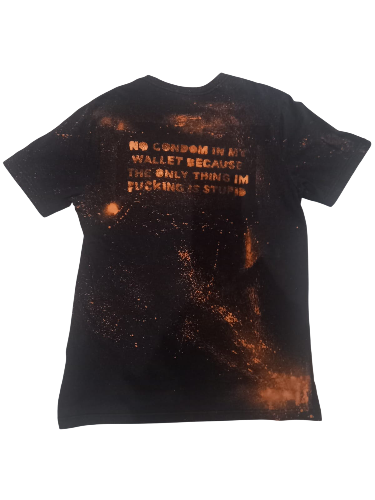 Back of a black shirt with copper bleach marks and hand-stencilled text