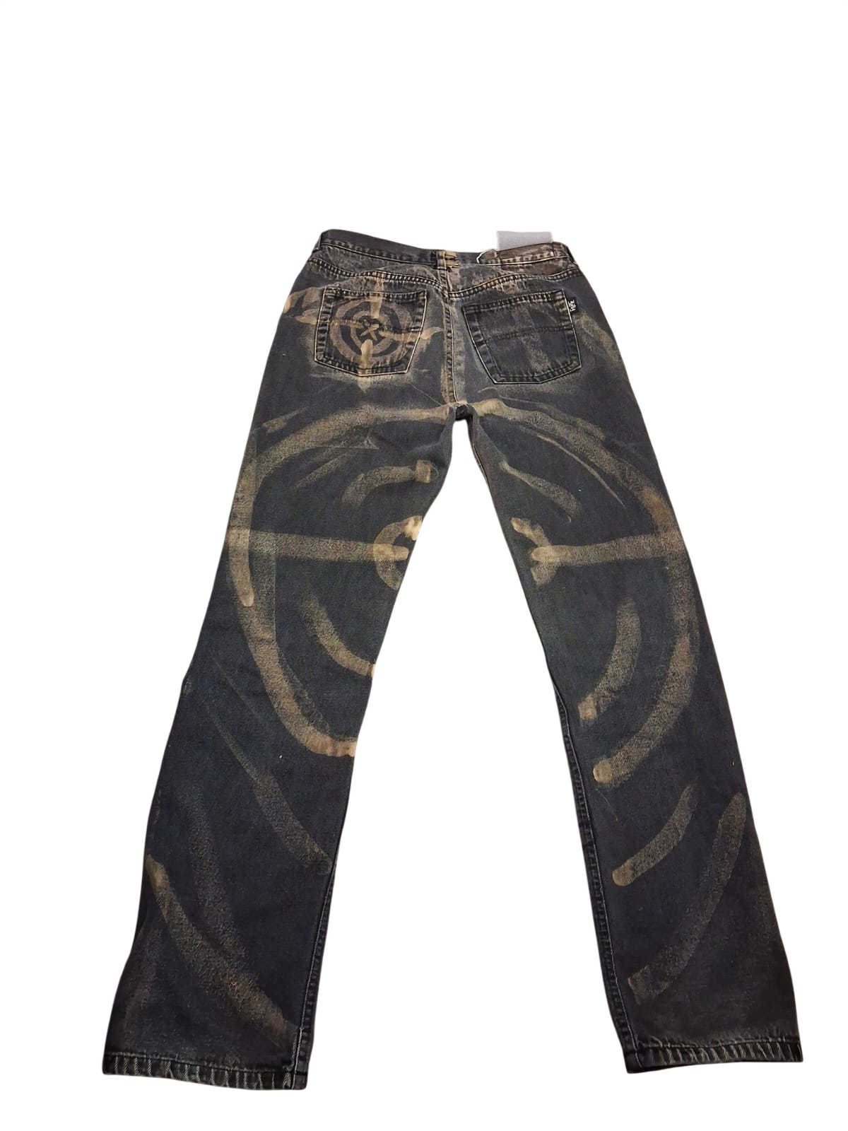 Back of dark jeans with a hand-painted circular design and curved bleach marks